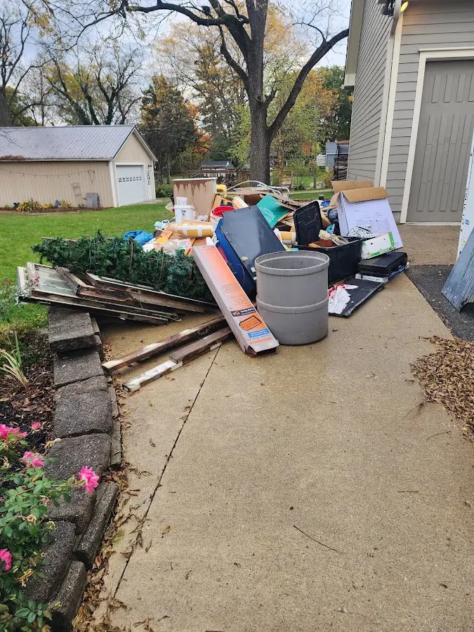 Dumpster being loaded with debris for 30 Yard Dumpster Rental in Selah